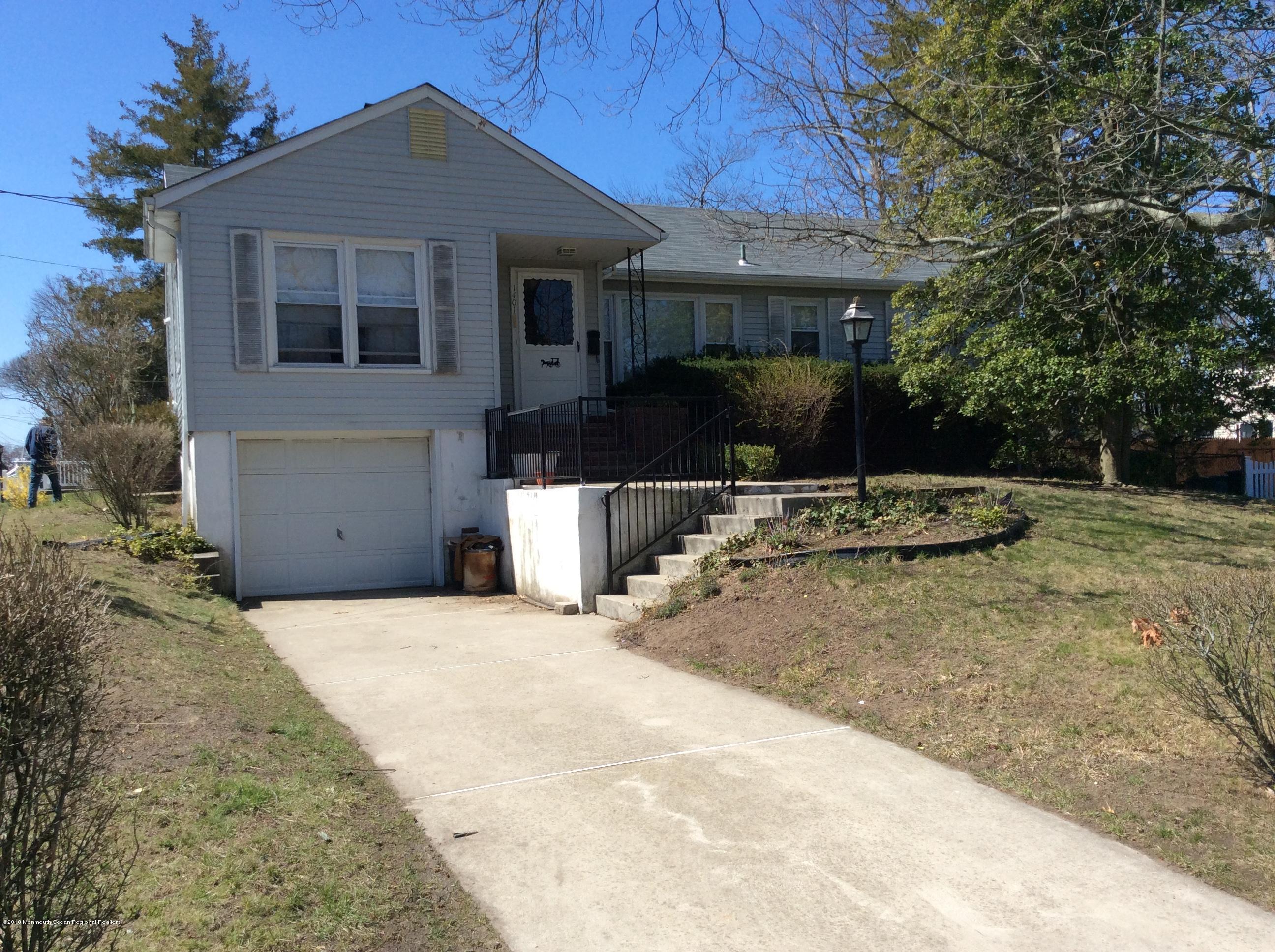 1401 Mossbank Road Point Pleasant, NJ 08742 - Photo 1 of 2 a front view of a house with a yard and garage
