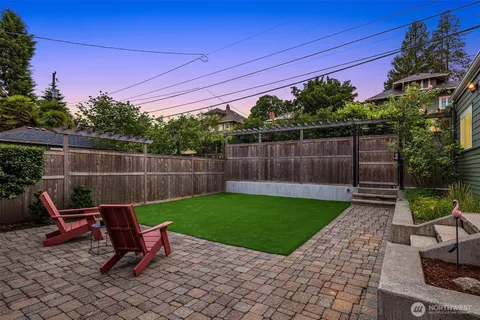 a view of a backyard with furniture and a garden