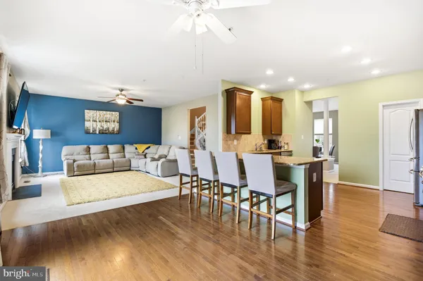 a view of a a dining room with furniture wooden floor and chandelier