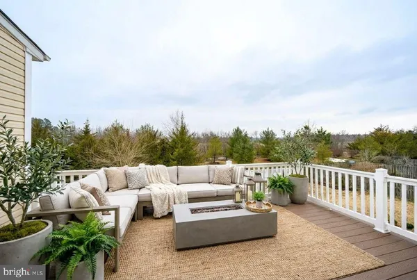 a view of roof with couches and wooden floor