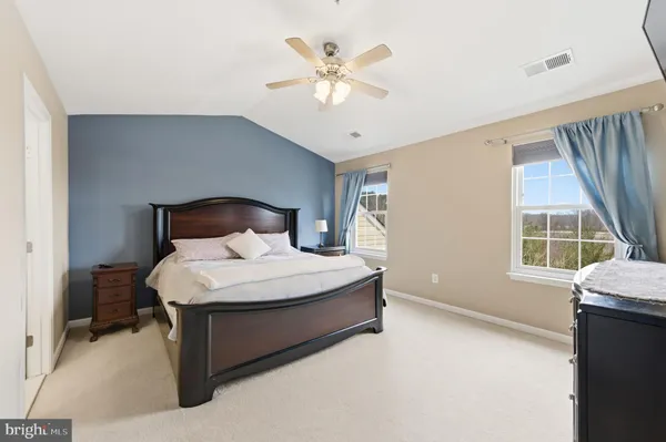 a bedroom with a large bed and a flat screen tv