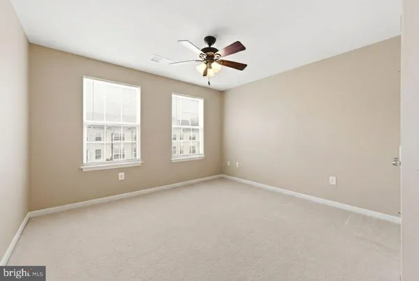 a spacious bedroom with a large bed and a window