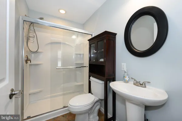 a view of a house with large windows and wooden fence
