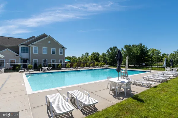 a view of a swimming pool and lounge chair