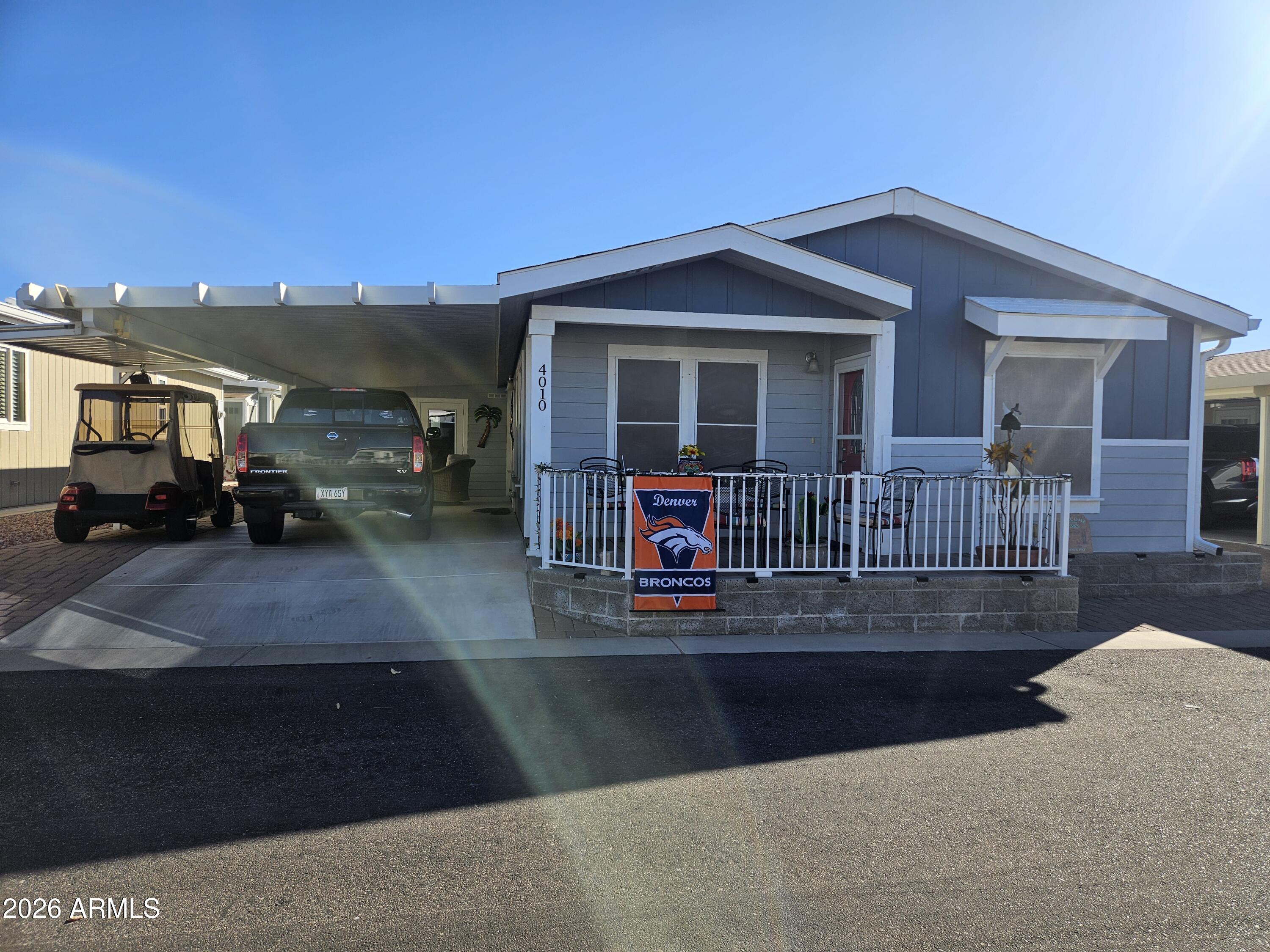 650 North Hawes Road, Unit 4010 Mesa, AZ 85207 - Photo 1 of 35 a view of a house with cars on the road