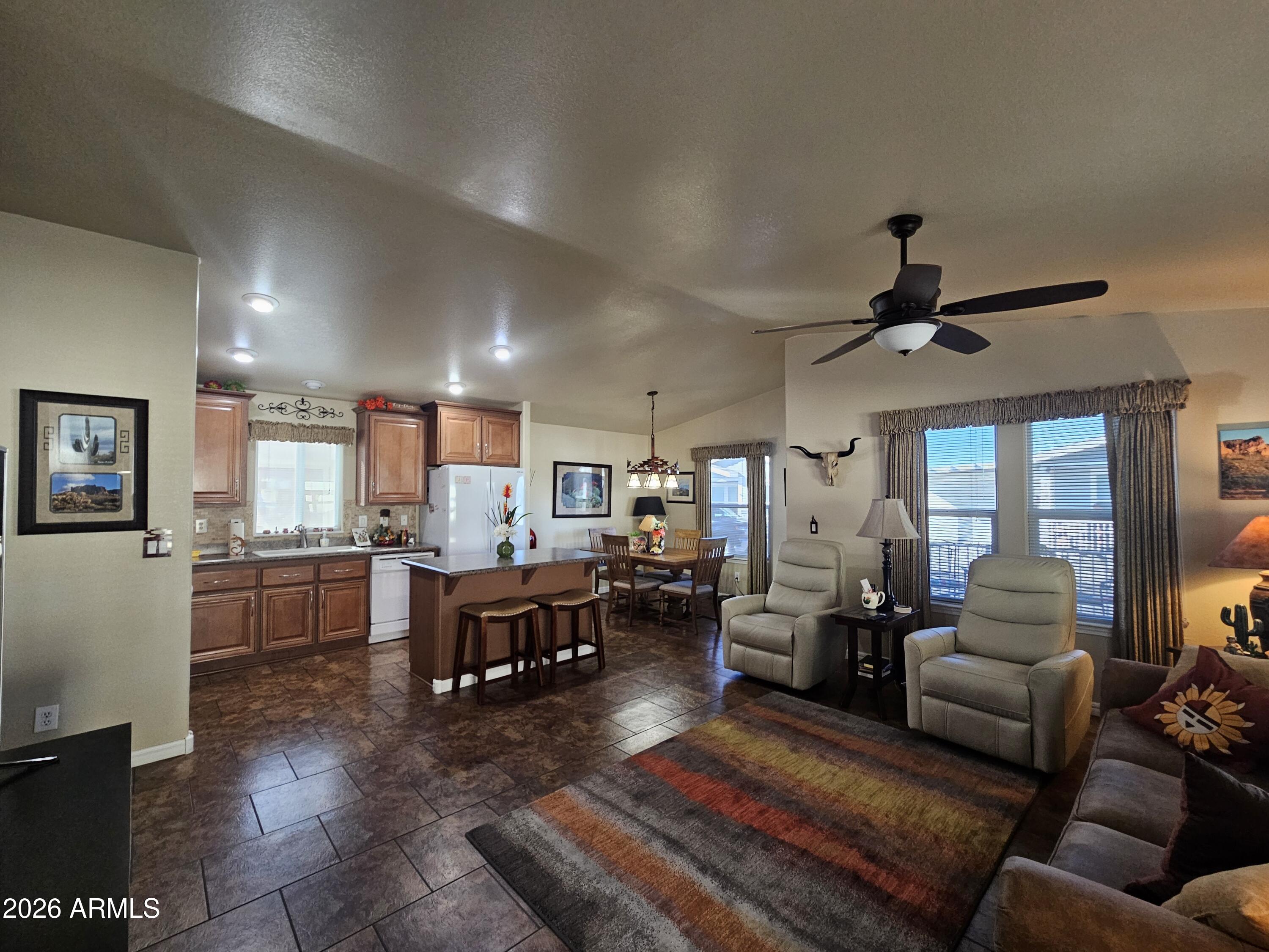 650 North Hawes Road, Unit 4010 Mesa, AZ 85207 - Photo 15 of 35 a living room with lots of furniture and kitchen view