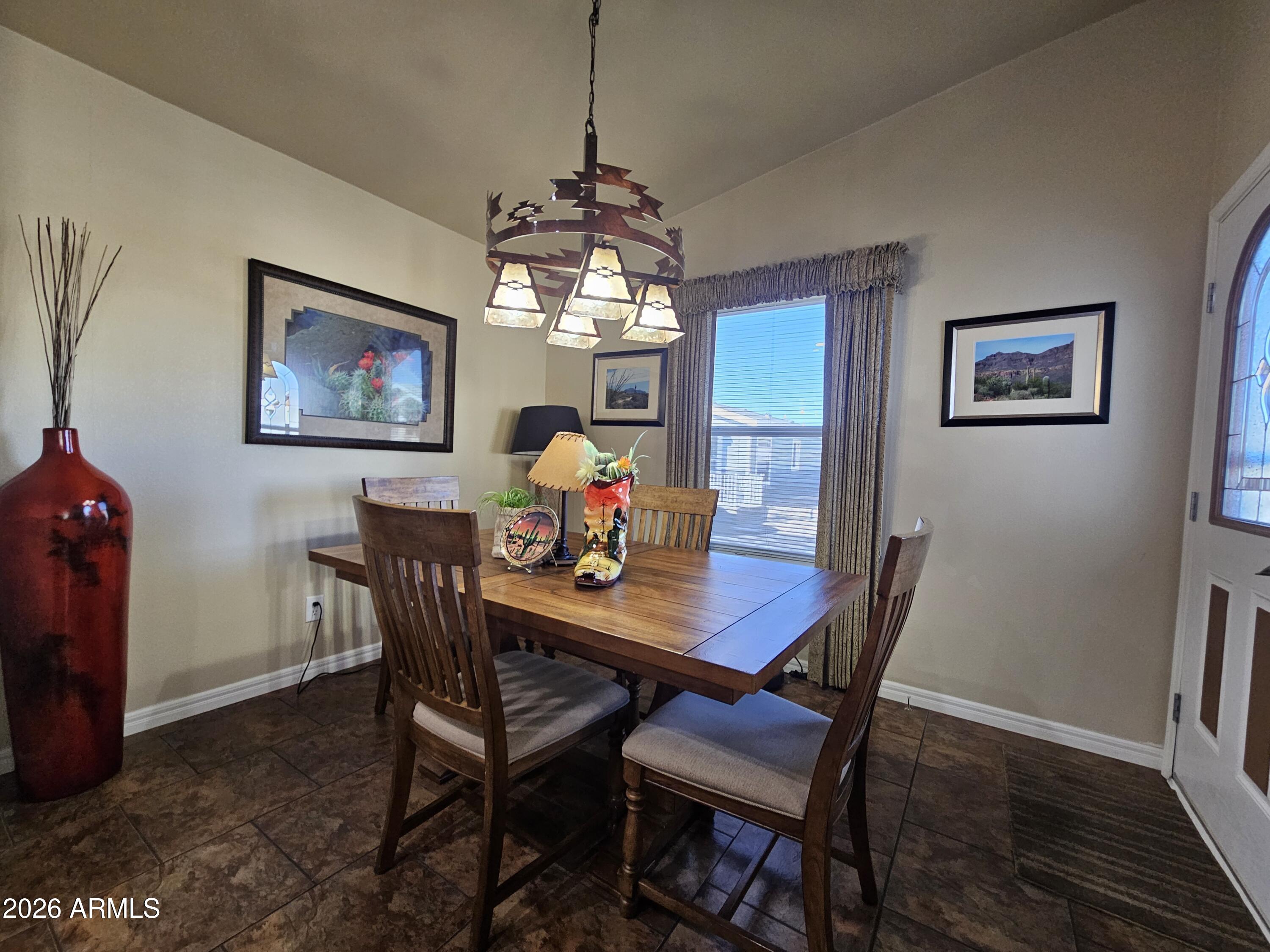 650 North Hawes Road, Unit 4010 Mesa, AZ 85207 - Photo 17 of 35 a view of a dining room with furniture a chandelier and wooden floor