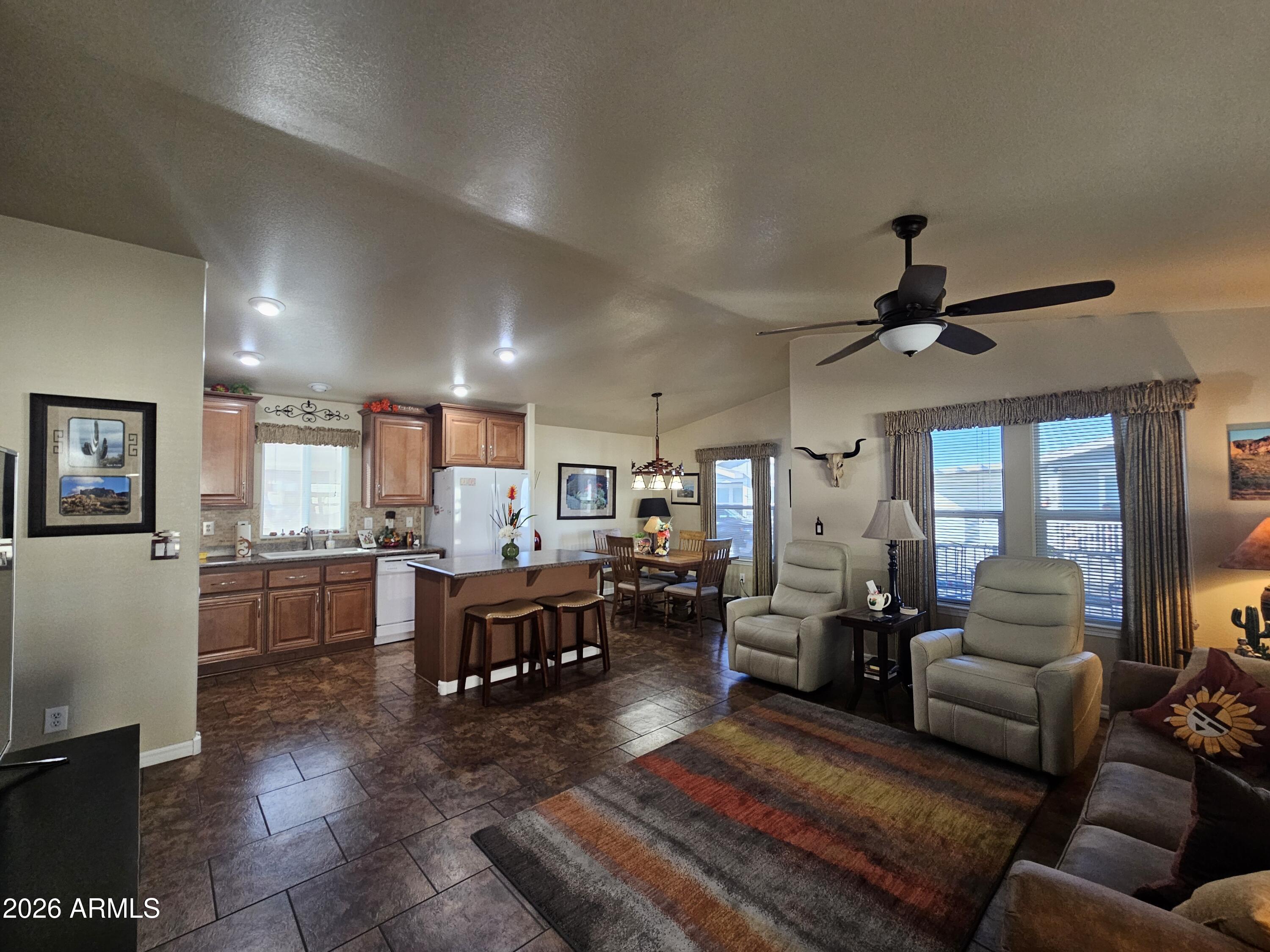 650 North Hawes Road, Unit 4010 Mesa, AZ 85207 - Photo 2 of 35 a living room with lots of furniture and kitchen view