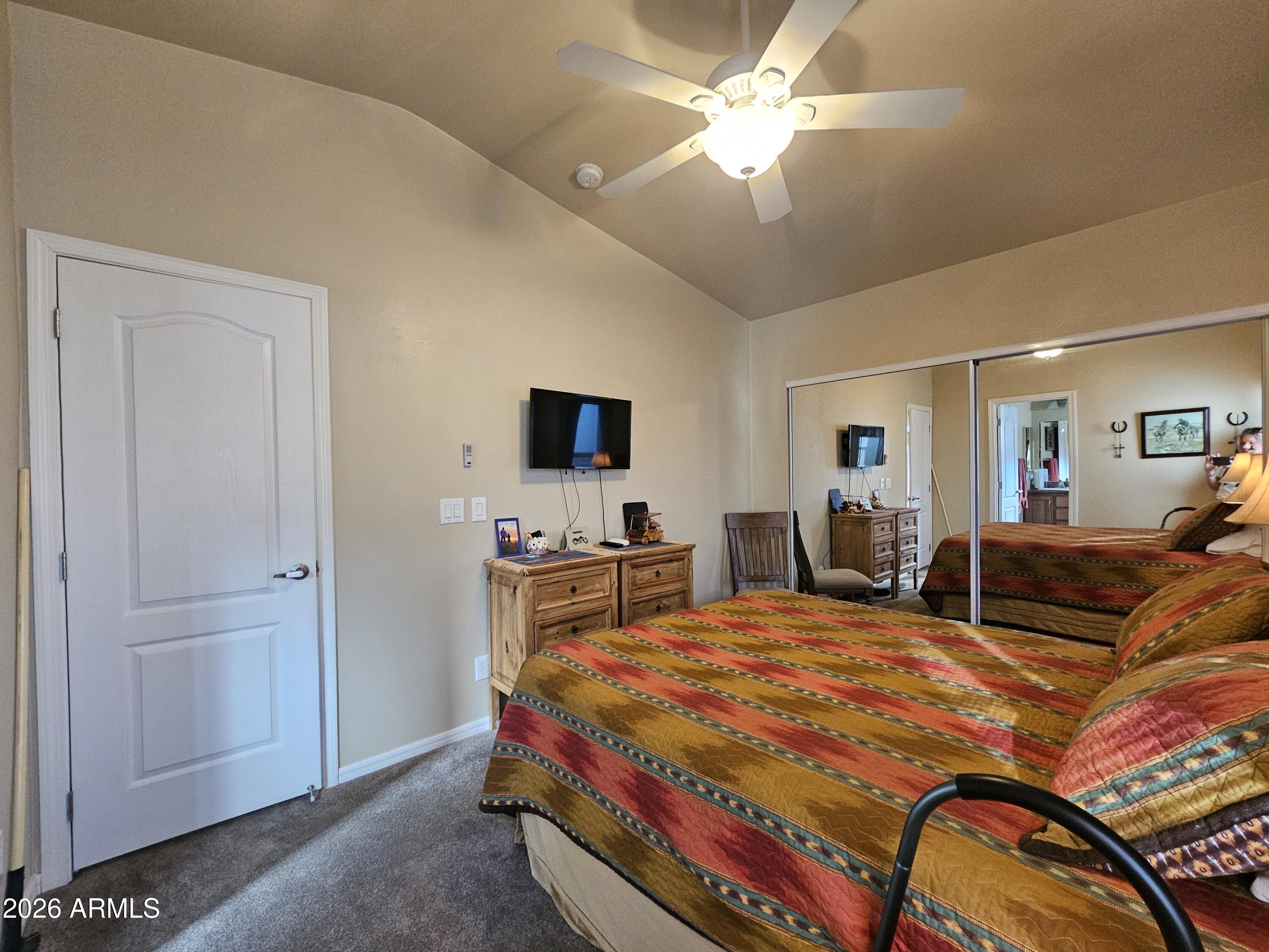 650 North Hawes Road, Unit 4010 Mesa, AZ 85207 - Photo 23 of 35 a bedroom with a bed and a chandelier