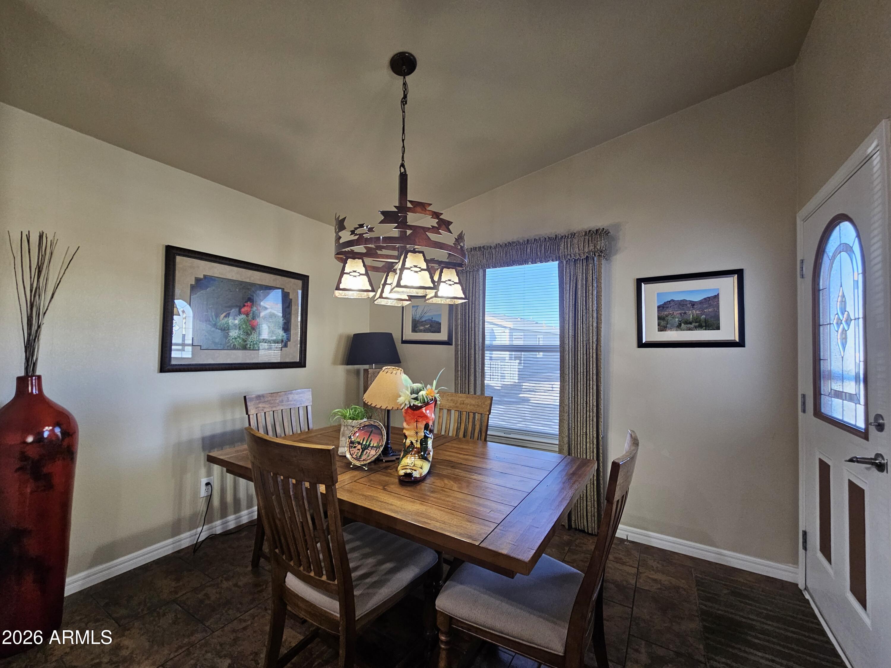 650 North Hawes Road, Unit 4010 Mesa, AZ 85207 - Photo 3 of 35 a view of a dining room with furniture a chandelier and wooden floor