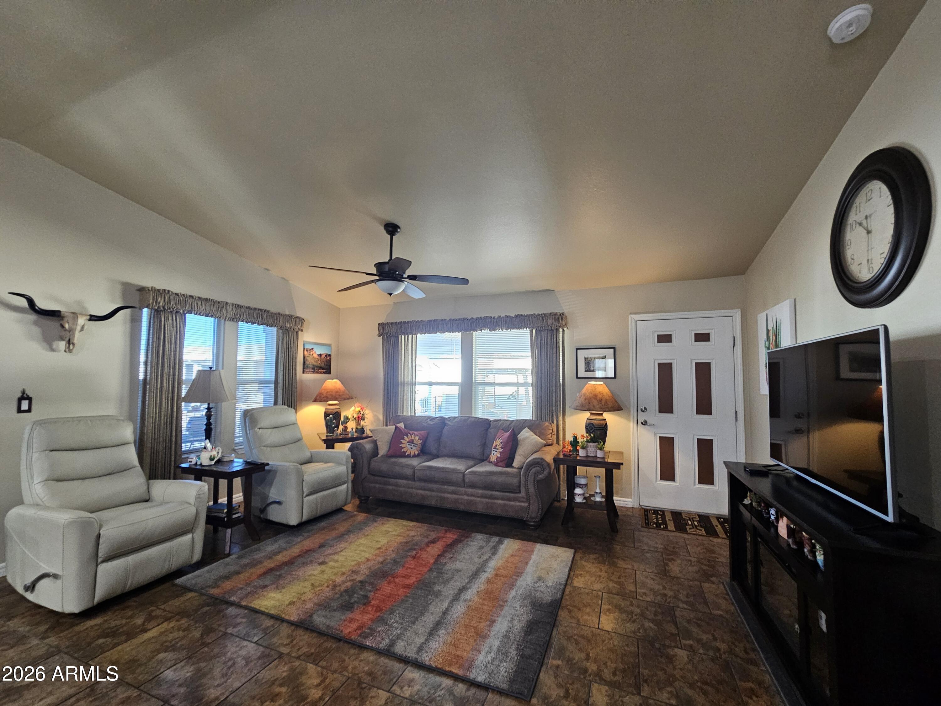 650 North Hawes Road, Unit 4010 Mesa, AZ 85207 - Photo 5 of 35 a living room with furniture and a flat screen tv