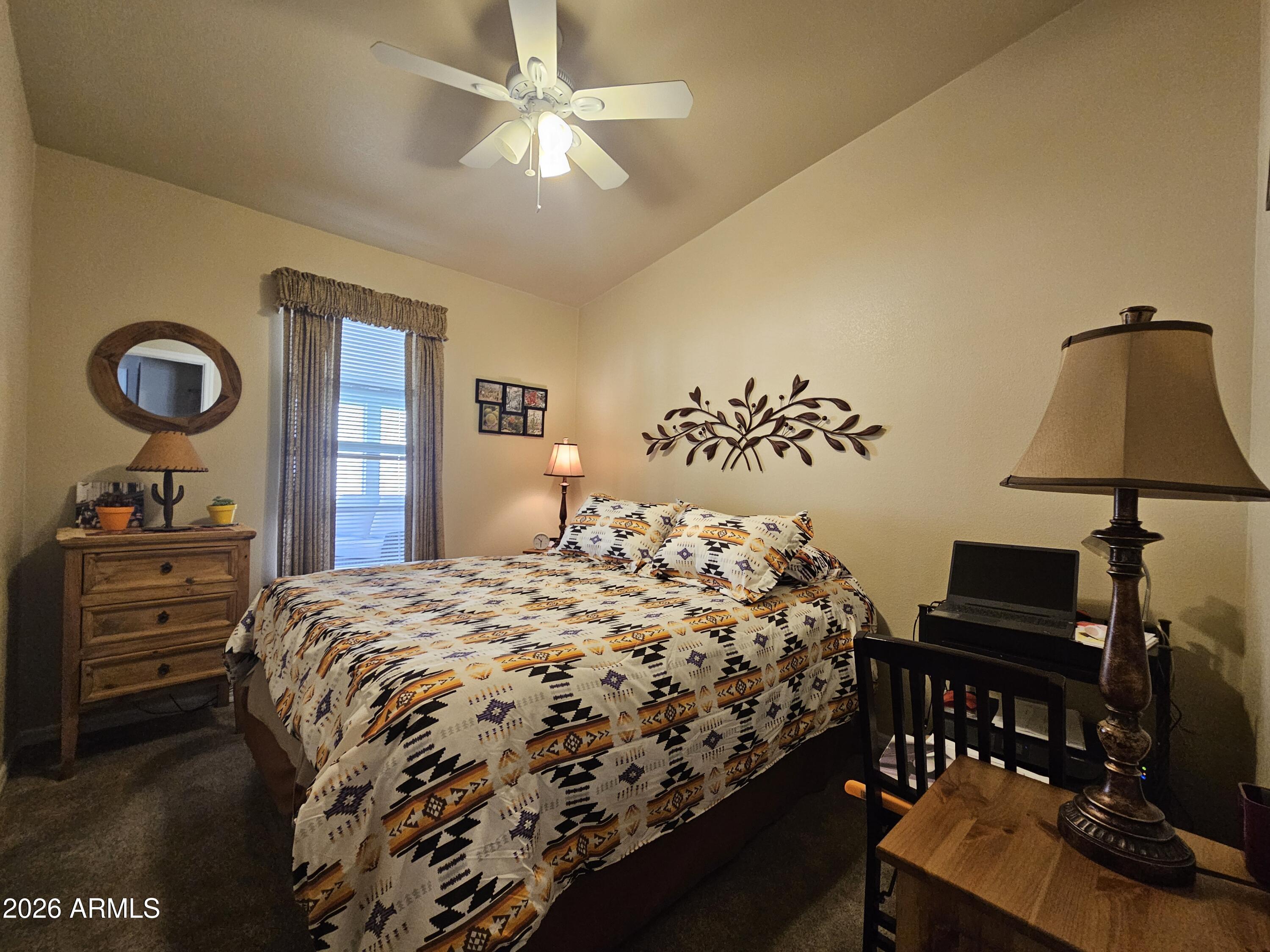 650 North Hawes Road, Unit 4010 Mesa, AZ 85207 - Photo 6 of 35 a bedroom with a bed and a chandelier