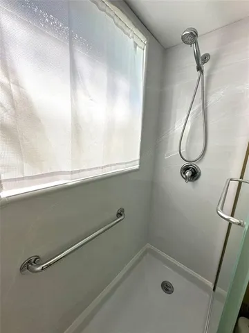 a bathroom with a granite countertop sink mirror vanity and toilet
