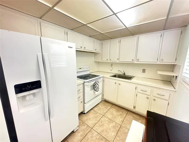 a kitchen with stainless steel appliances a refrigerator sink and cabinets