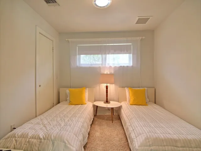 a bedroom with a bed and a night stand