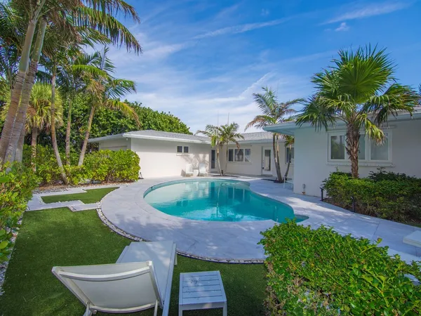 a view of a house with swimming pool and a yard