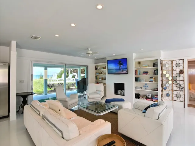 a living room with fireplace furniture and a large window