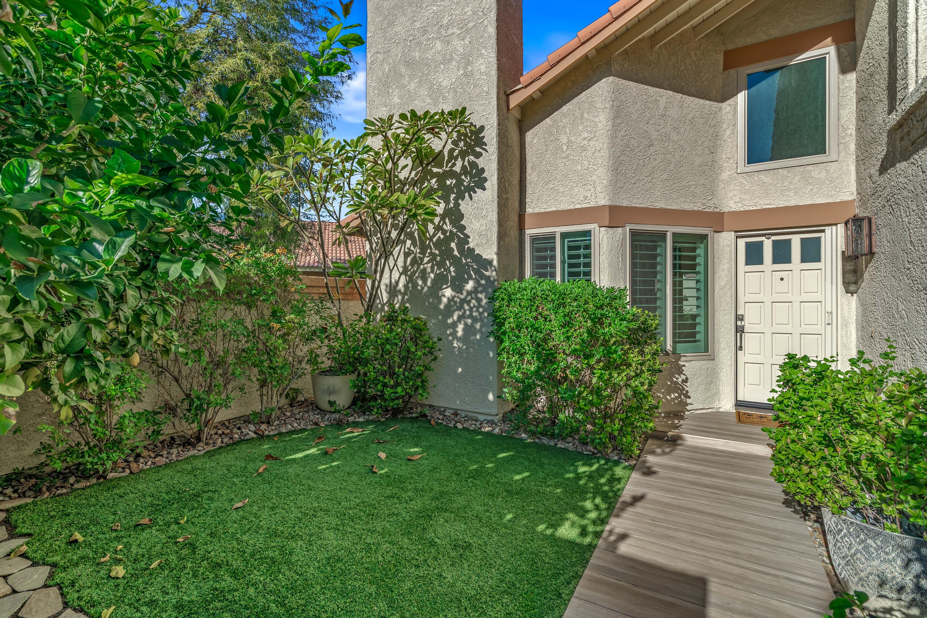 76632 Morocco Road Palm Desert, CA 92211 - Photo 1 of 38 a view of a pathway with house on both side
