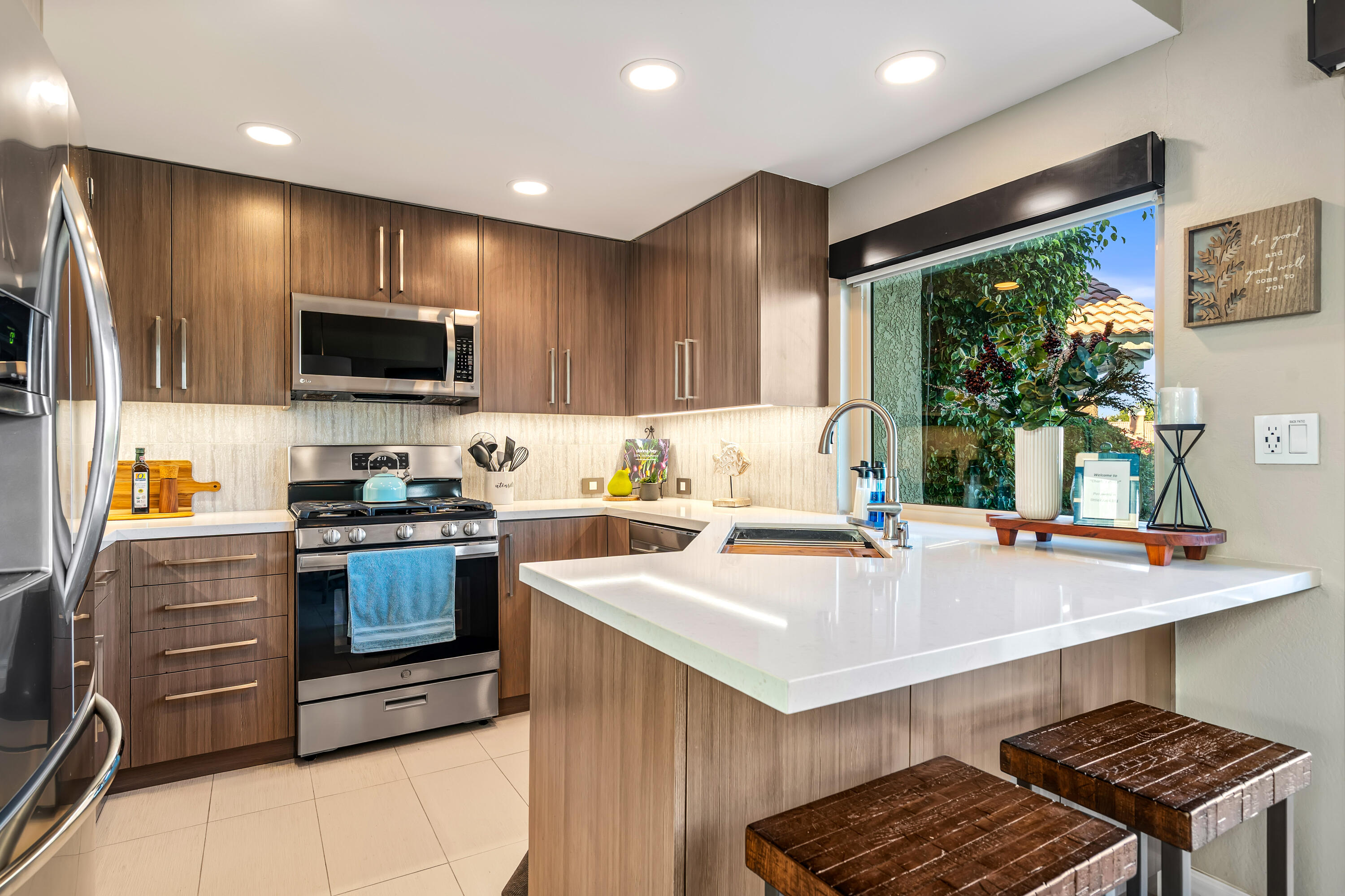 76632 Morocco Road Palm Desert, CA 92211 - Photo 12 of 38 a kitchen with a stove a sink and a microwave