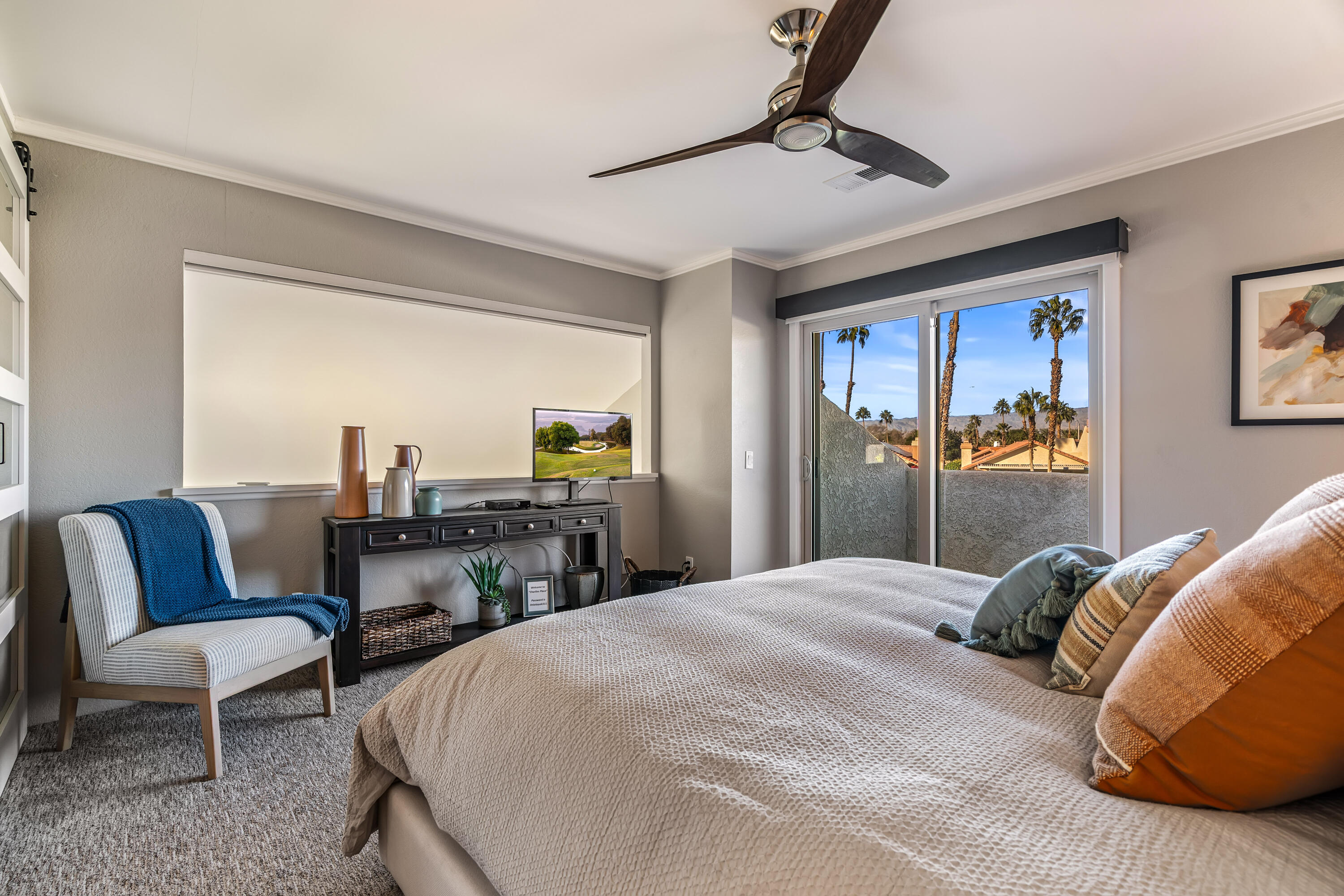 76632 Morocco Road Palm Desert, CA 92211 - Photo 15 of 38 a bedroom with a bed a couch and a potted plant on the dresser
