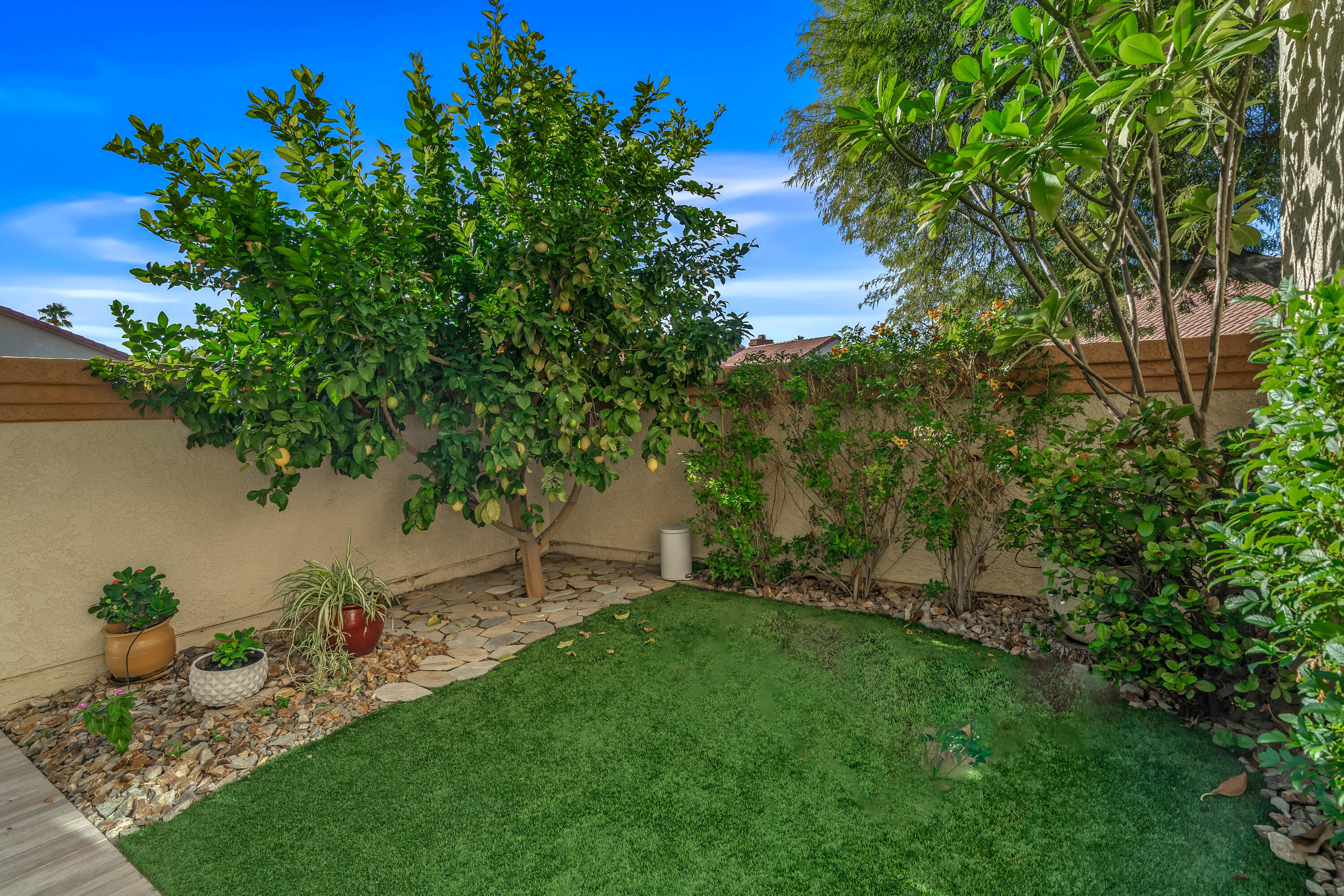 76632 Morocco Road Palm Desert, CA 92211 - Photo 2 of 38 a view of a backyard with a garden