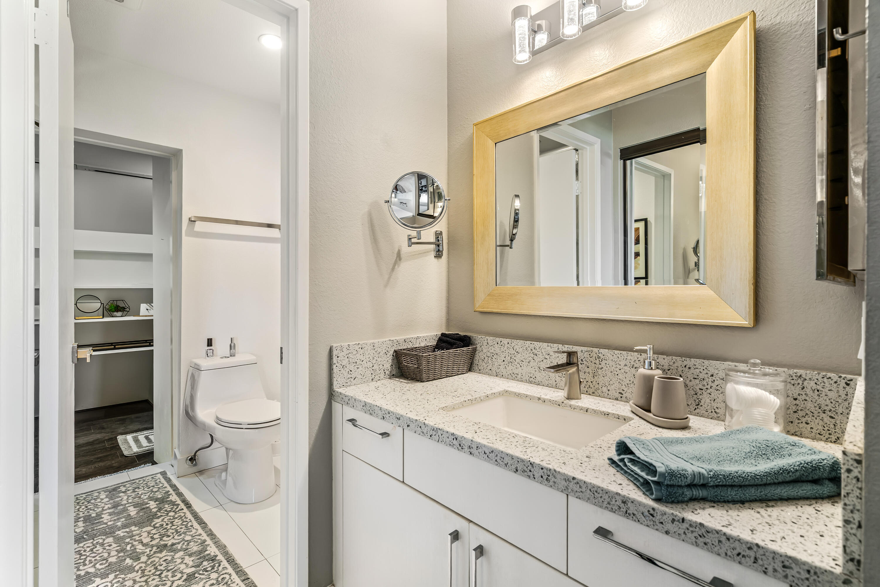 76632 Morocco Road Palm Desert, CA 92211 - Photo 22 of 38 a bathroom with a granite countertop sink and a mirror