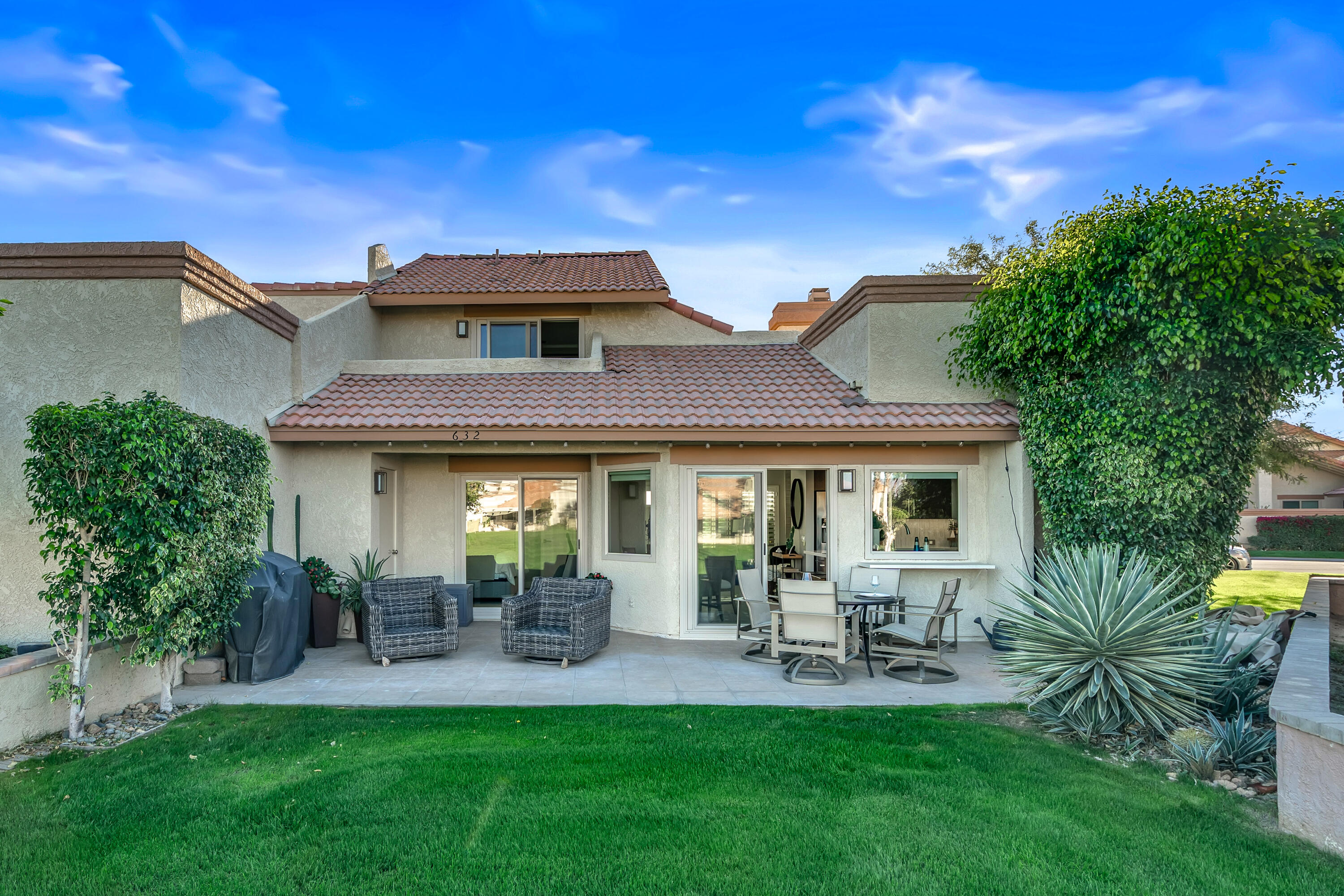 76632 Morocco Road Palm Desert, CA 92211 - Photo 25 of 38 a front view of a house with patio and garden