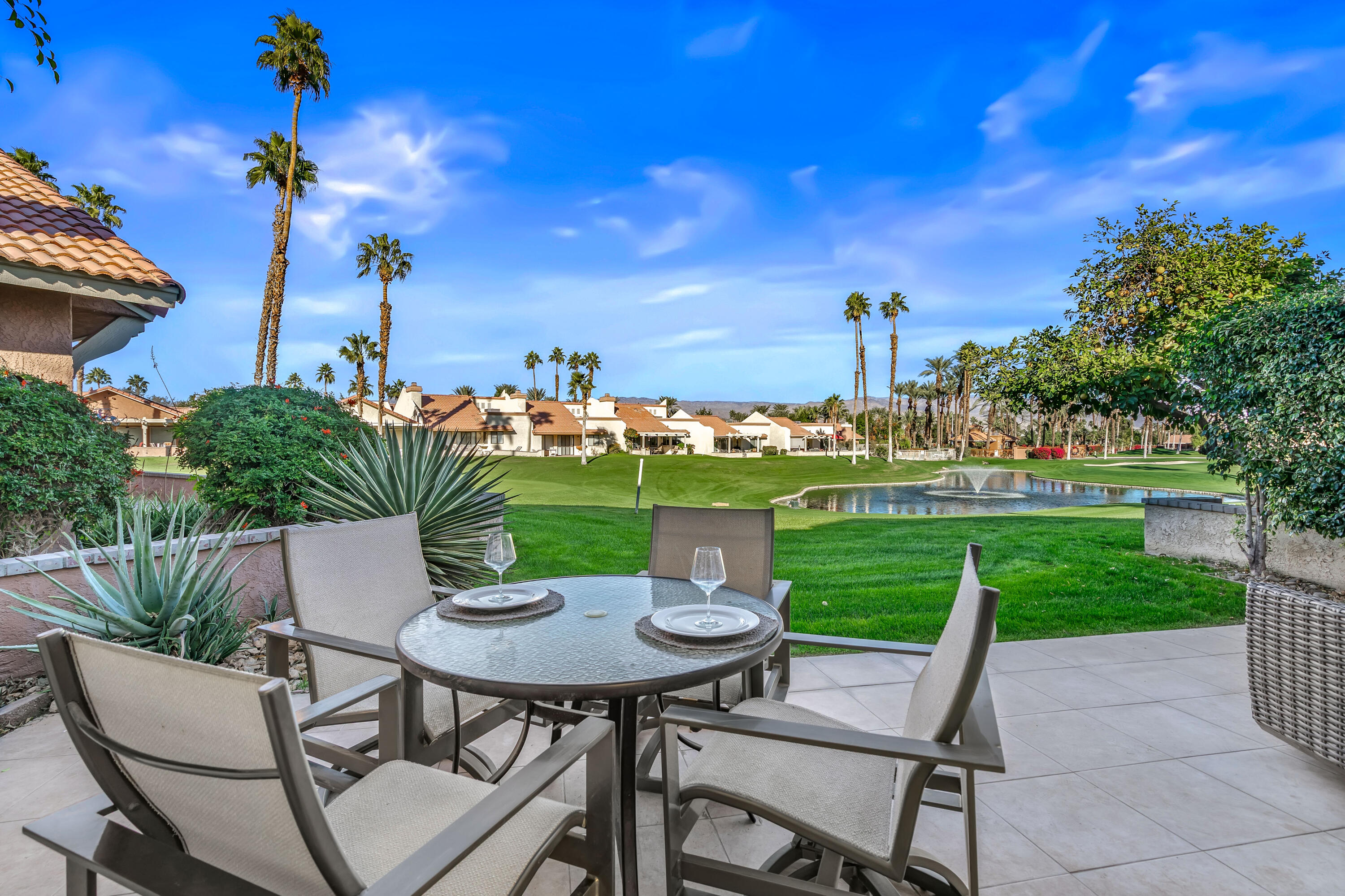 76632 Morocco Road Palm Desert, CA 92211 - Photo 26 of 38 a view of a chairs and table in patio next to a yard