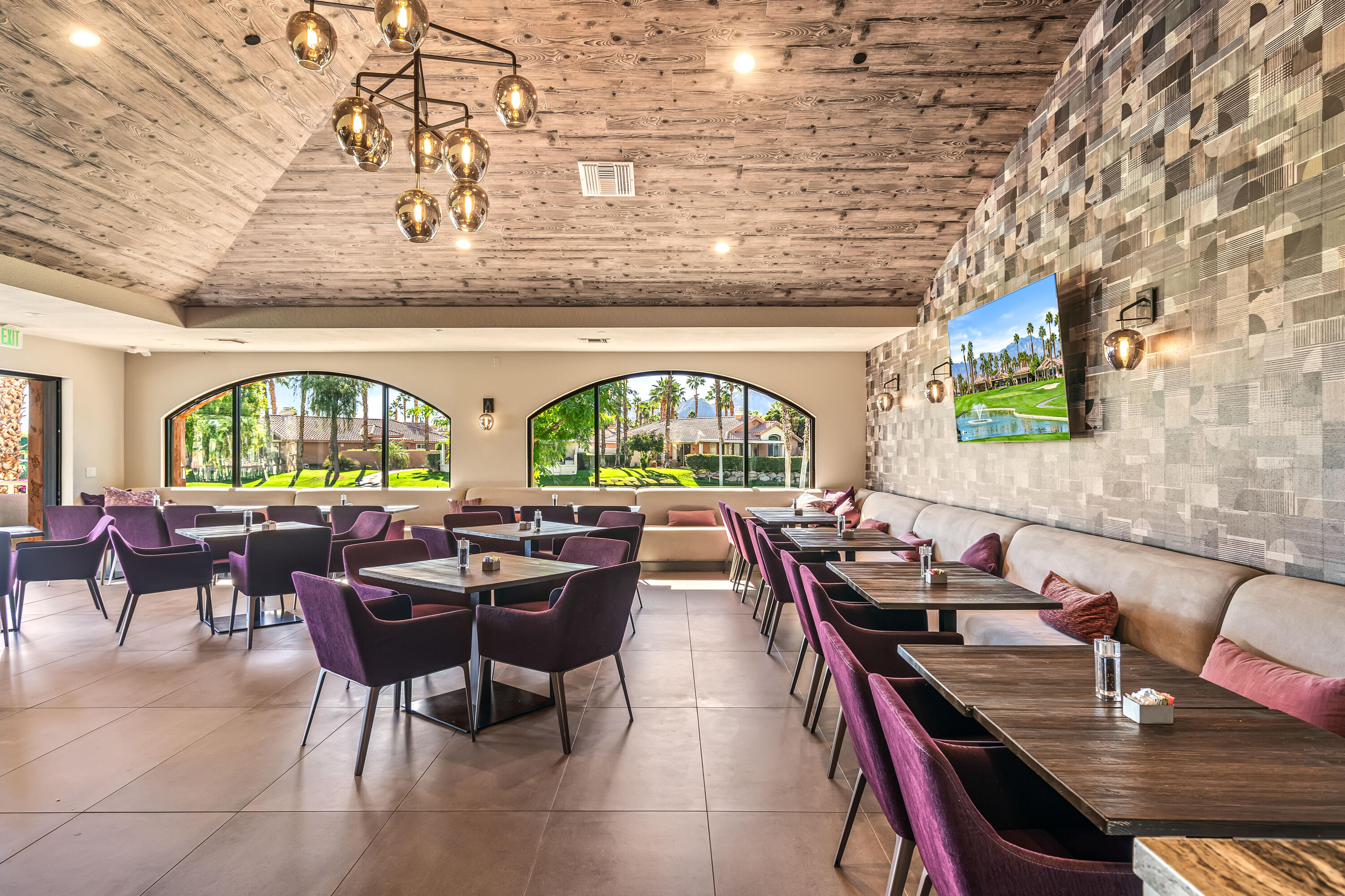 76632 Morocco Road Palm Desert, CA 92211 - Photo 33 of 38 a view of a dining room with furniture a chandelier and wooden floor