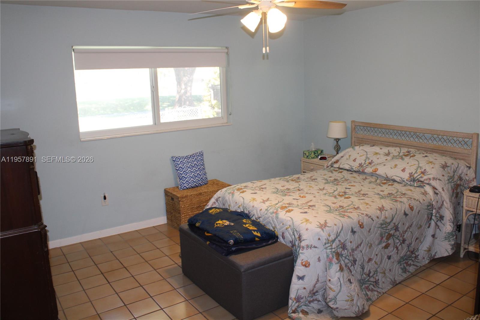 12965 Southwest 76th Terrace Miami, FL 33183 - Photo 25 of 29 a bedroom with a bed and a window