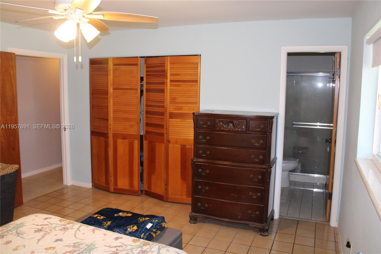 12965 Southwest 76th Terrace Miami, FL 33183 - Photo 26 of 29 a bedroom with a bed and a cabinets