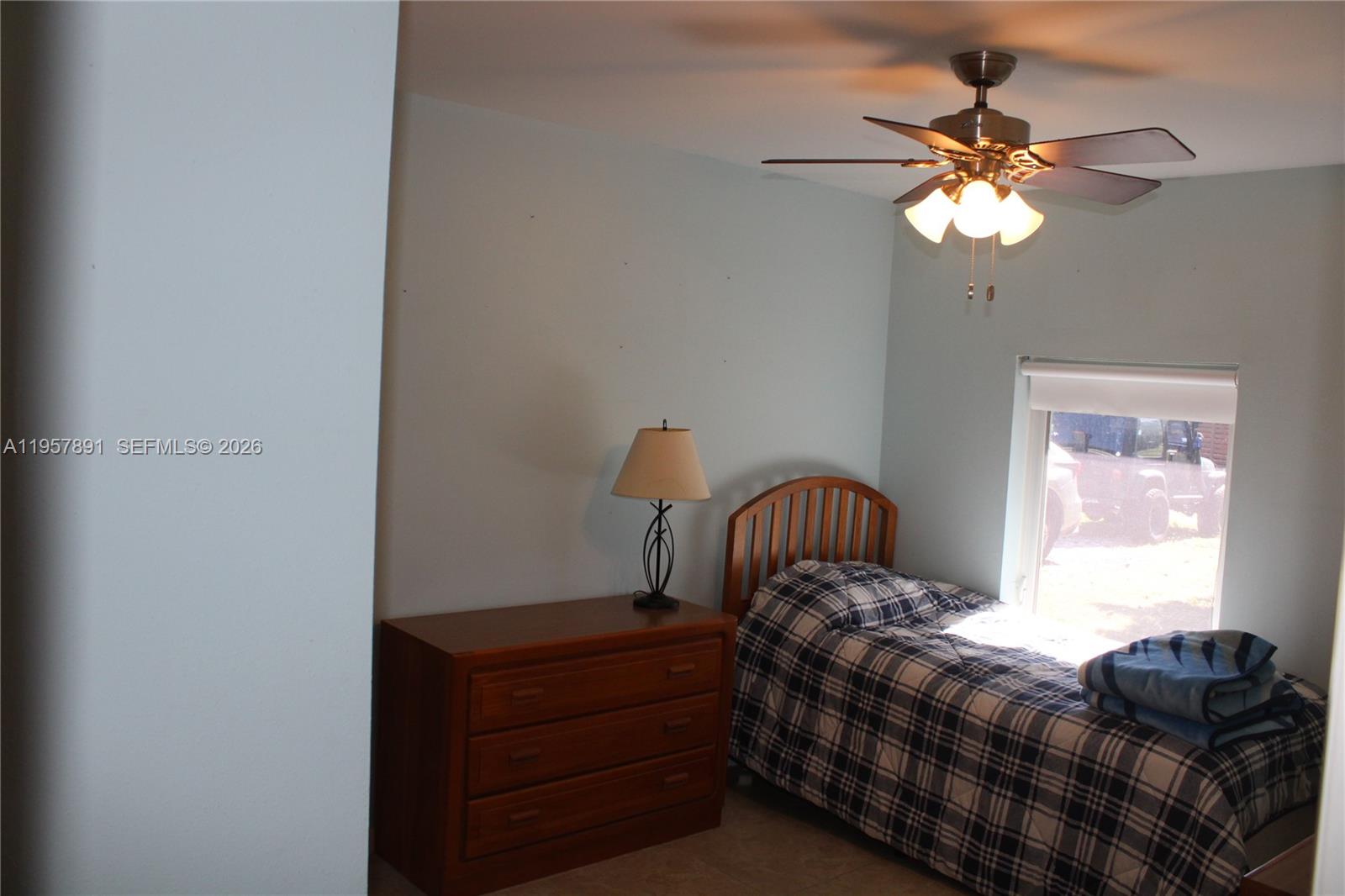 12965 Southwest 76th Terrace Miami, FL 33183 - Photo 27 of 29 a bedroom with a bed and window
