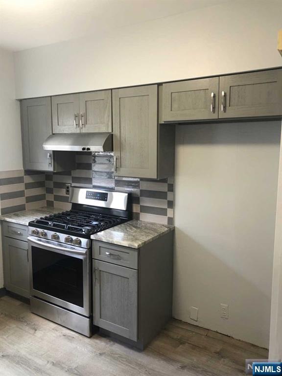 15 East Van Ness Avenue, Unit 1 Rutherford, NJ 07070 - Photo 11 of 25 a kitchen with granite countertop a stove and a cabinets