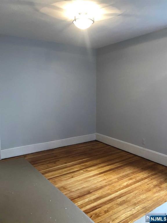 15 East Van Ness Avenue, Unit 1 Rutherford, NJ 07070 - Photo 20 of 25 a view of a room with wooden floor and carpet