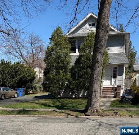 15 East Van Ness Avenue, Unit 1 Rutherford, NJ 07070 - Photo 25 of 25 a front view of a house with a yard