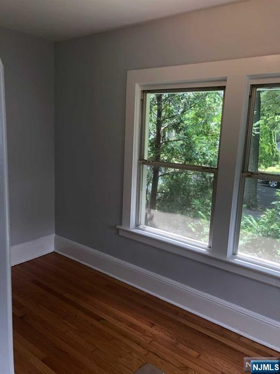 15 East Van Ness Avenue, Unit 1 Rutherford, NJ 07070 - Photo 6 of 25 a view of empty room with wooden floor and fan