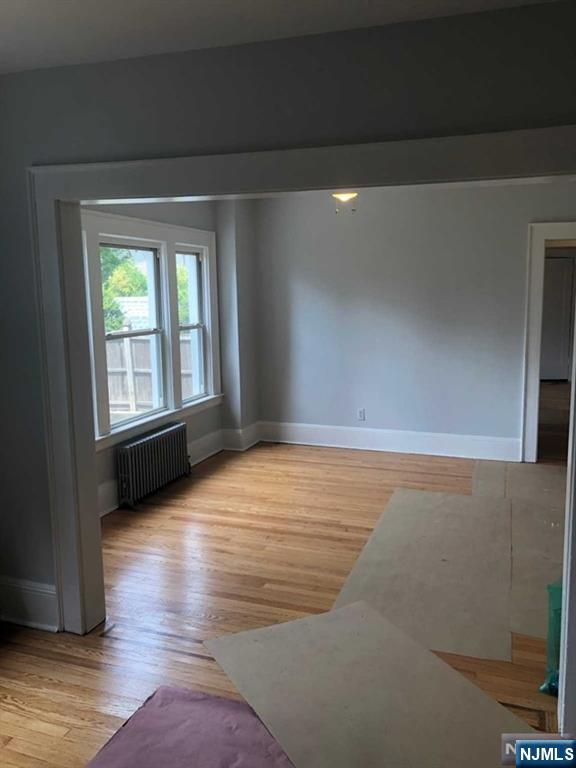 15 East Van Ness Avenue, Unit 1 Rutherford, NJ 07070 - Photo 7 of 25 a view of an empty room with wooden floor and a window