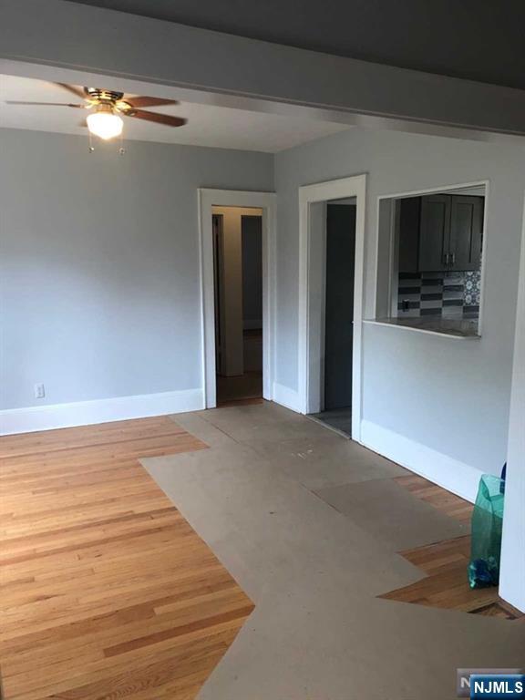 15 East Van Ness Avenue, Unit 1 Rutherford, NJ 07070 - Photo 8 of 25 a view of a livingroom with an empty space and a window