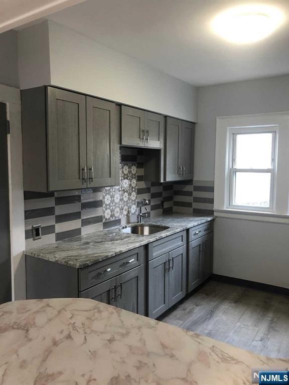 15 East Van Ness Avenue, Unit 1 Rutherford, NJ 07070 - Photo 9 of 25 a kitchen with stainless steel appliances granite countertop a stove a sink and a microwave