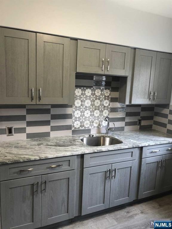 15 East Van Ness Avenue, Unit 1 Rutherford, NJ 07070 - Photo 10 of 25 a kitchen with stainless steel appliances granite countertop a sink and cabinets
