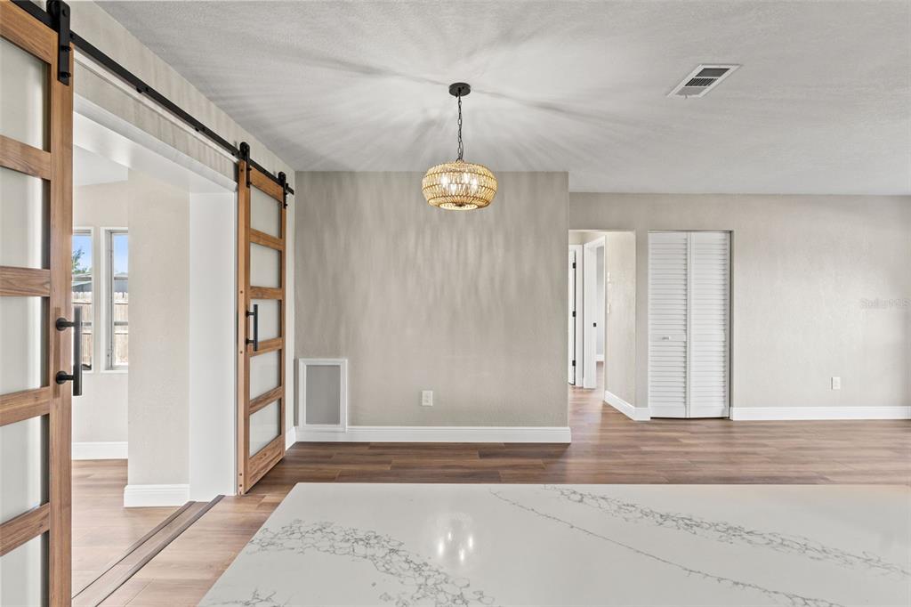 1173 Cobblestone Drive Spring Hill, FL 34606 - Photo 14 of 39 a view of a hallway with windows and entryway