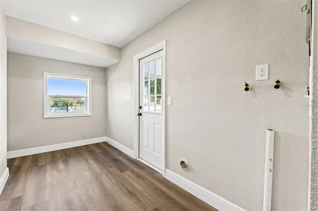 a view of room with window and hardwood floor