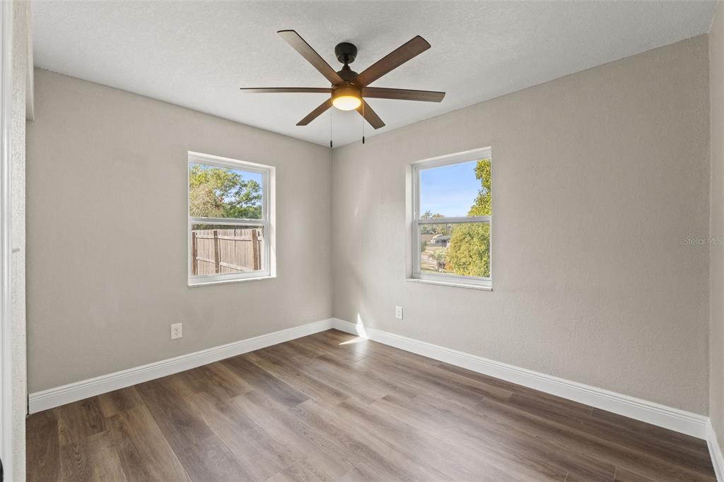 1173 Cobblestone Drive Spring Hill, FL 34606 - Photo 27 of 39 an empty room with wooden floor and windows