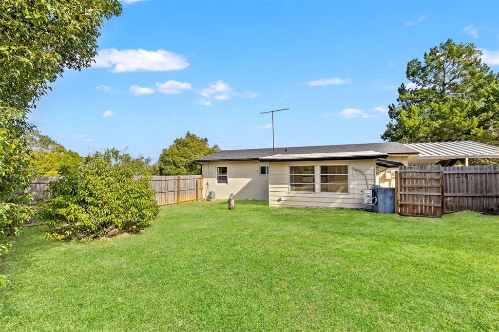 1173 Cobblestone Drive Spring Hill, FL 34606 - Photo 32 of 39 a view of a house with a yard and sitting area
