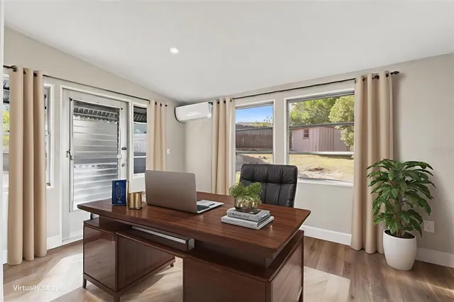 a view of a workspace with furniture and a potted plant