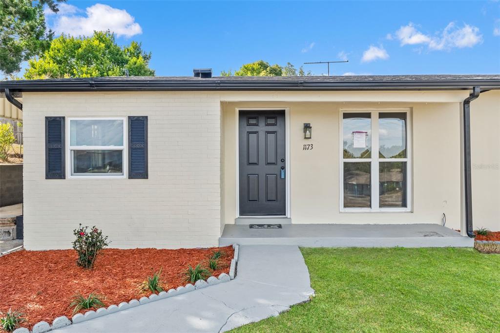 1173 Cobblestone Drive Spring Hill, FL 34606 - Photo 9 of 39 a front view of a house with a yard
