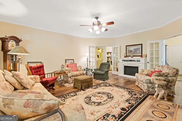 a living room with furniture a fireplace and a chandelier