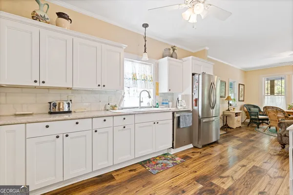 a kitchen with sink refrigerator and window