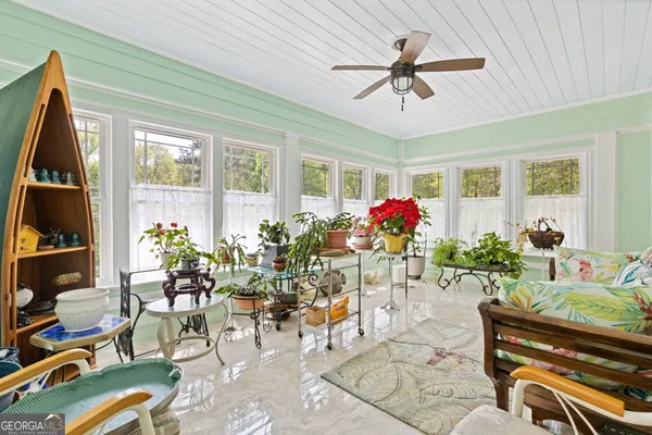 a living room filled with furniture chandelier and a window