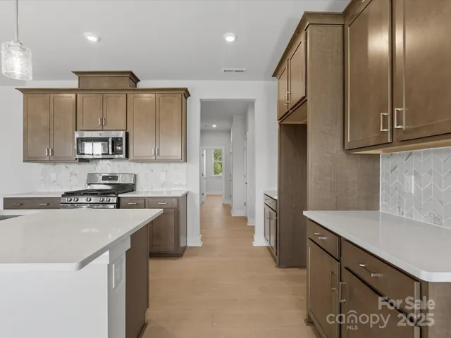 a kitchen with a sink stove and refrigerator